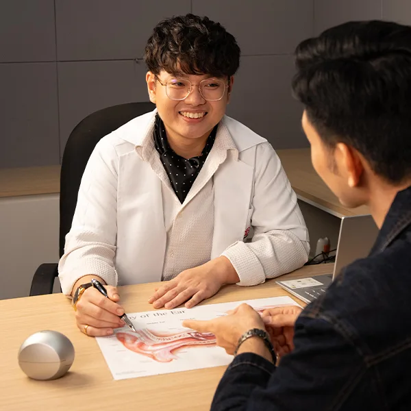 20dB audiologist explaining hearing test results to a patient