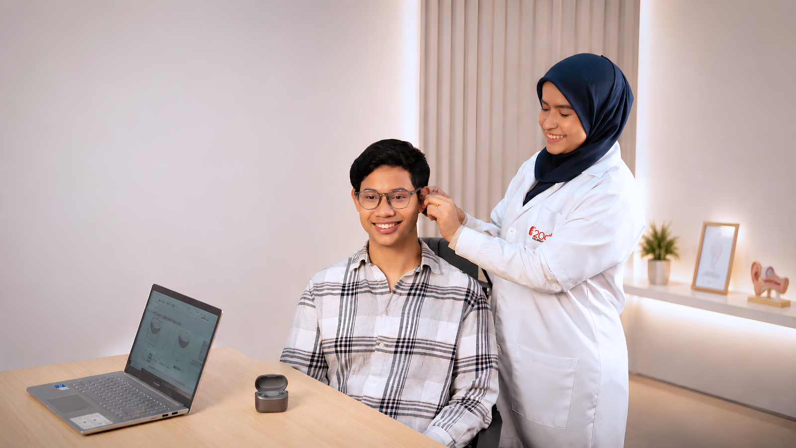 20dB audiologist fitting a hearing aid for a patient
