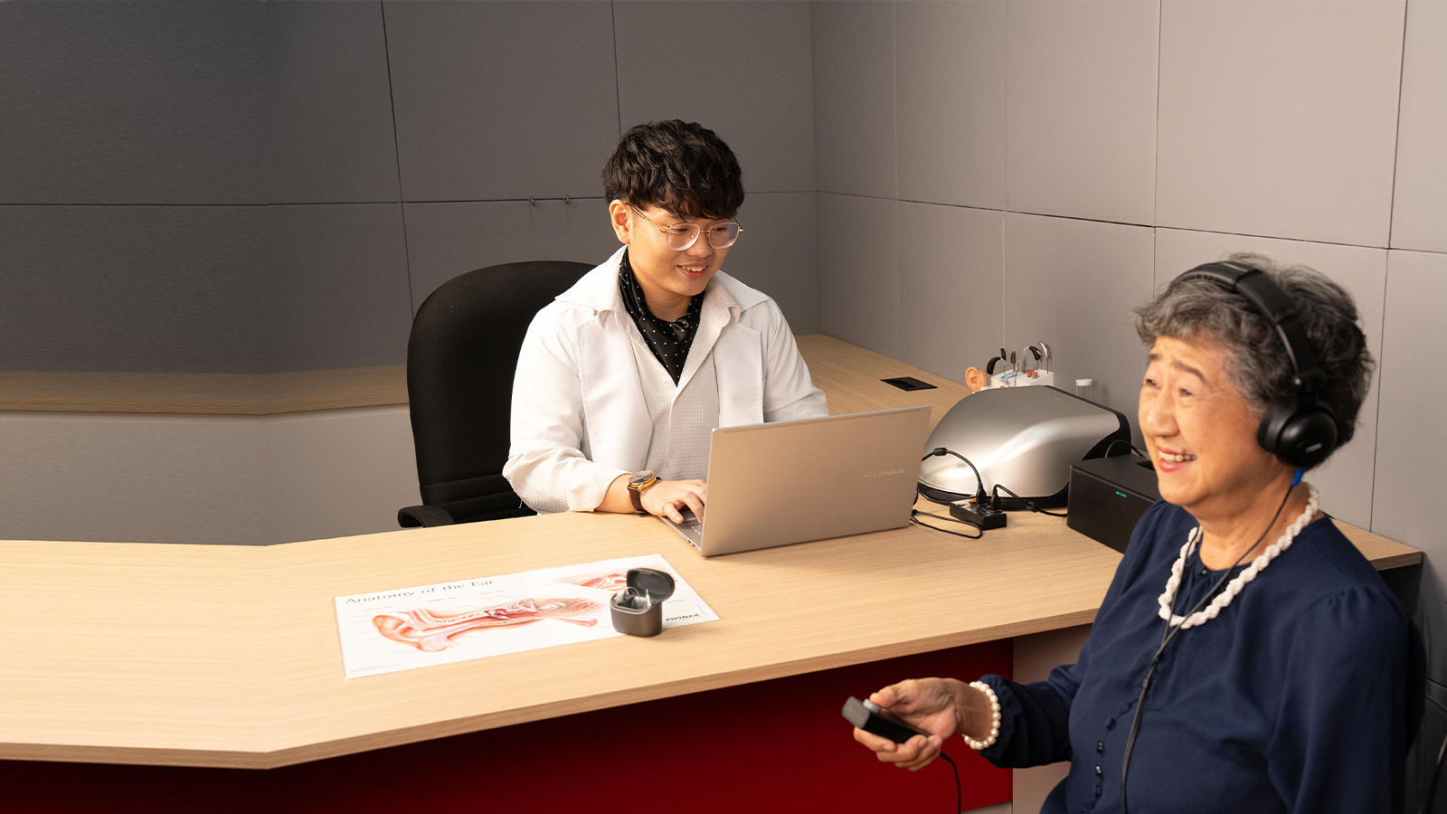 20dB Audiologist conducting hearing check